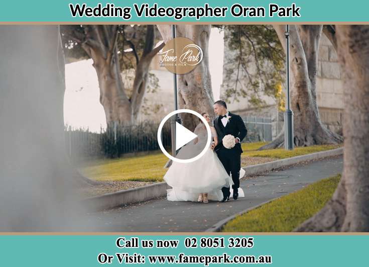 The Groom and the Bride walking in the park Oran Park NSW 2570